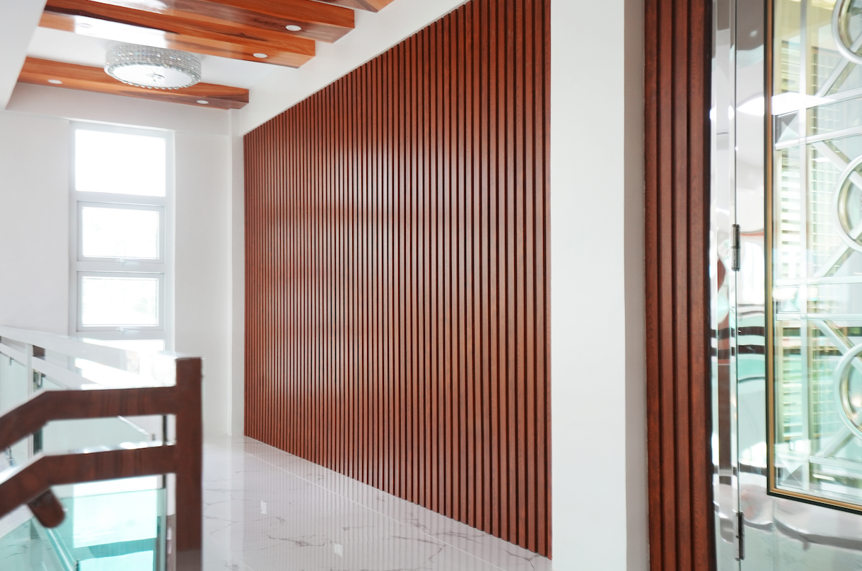 Premium Decolite WPC wall panel feature wall in a contemporary Philippine home hallway, showing a sleek alternative to traditional ceramic wall tiles.